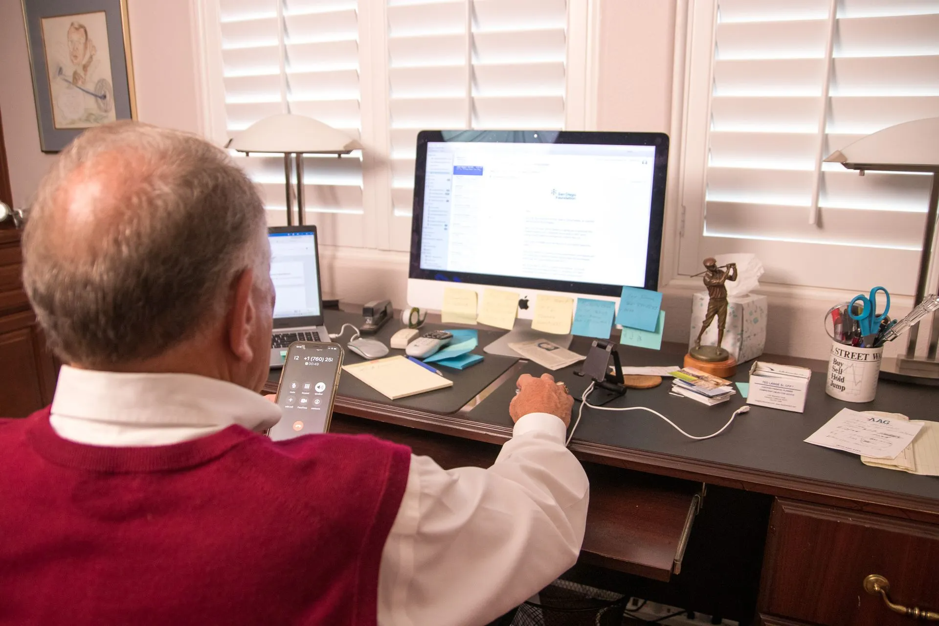 Person using computer and phone