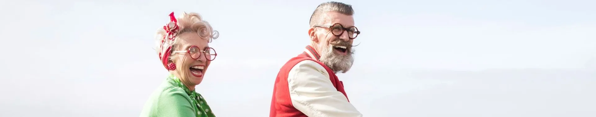 Elderly couple laughing together outdoors
